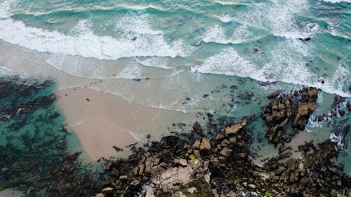 Aerial view on waves hitting shore