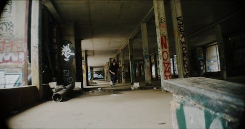 A Man Skating on an Abandoned Building