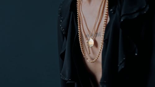 A Man Holding His Gold Necklace