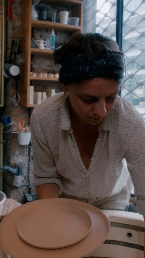 Woman Putting Plates Together 