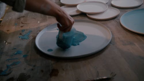 A Person Pouring Paint on a Plate