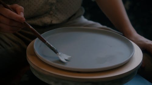 Close-up Footage of a Person Painting Design on a Plate