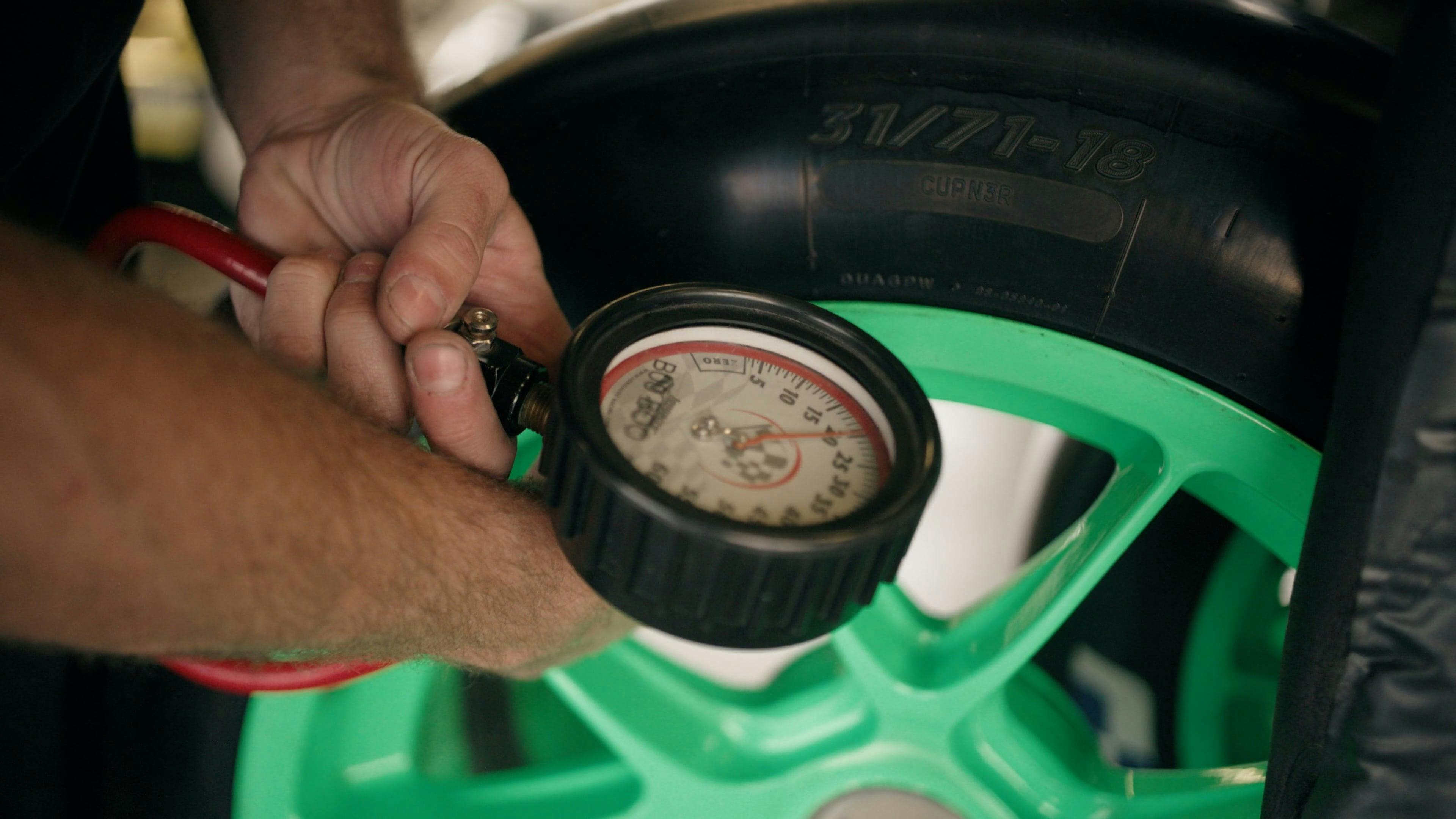 Man measuring air pressure in tires Free Stock Video Footage, Royalty