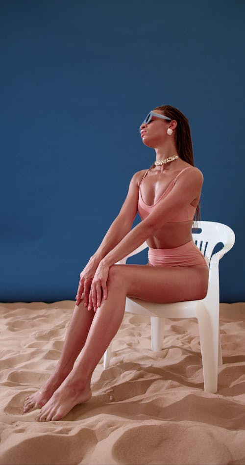 Woman Wearing Bikini Sitting on a Chair