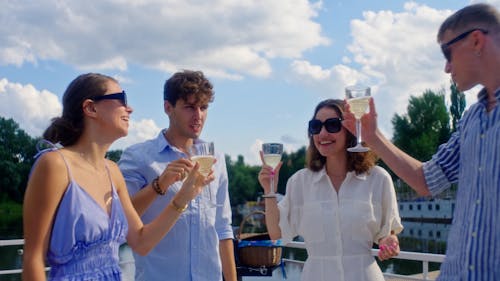 People Toasting their Glasses of White Wine