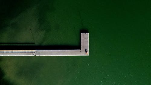 View from above on people standing on wooden pier