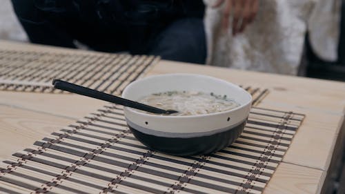 Close up of a Bowl of Hot Noodle Soup on a Table