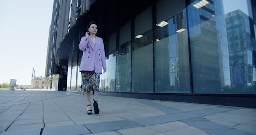 A Woman Walking Outside the Building