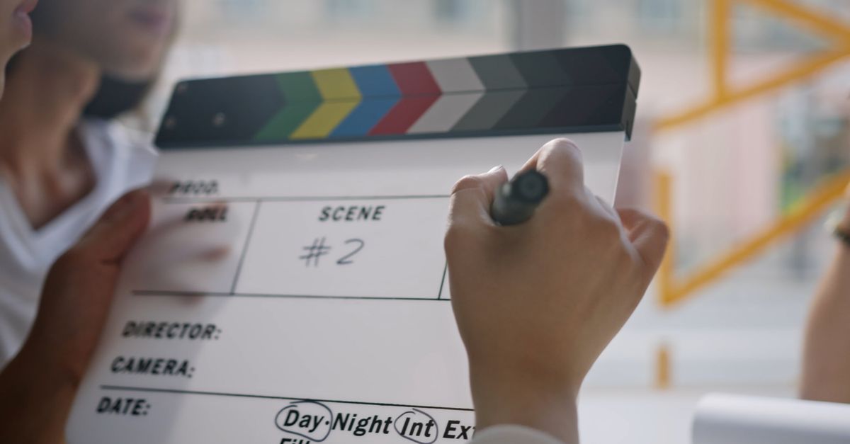 Video Writing Board Filmmaker writing on clapperboard Free Stock Video Footage, Royalty ...