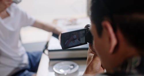 A Cameraman Recording a Scene