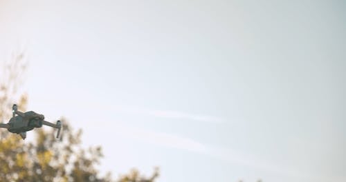 Drone Flying and Hovering on Sunlit Sky