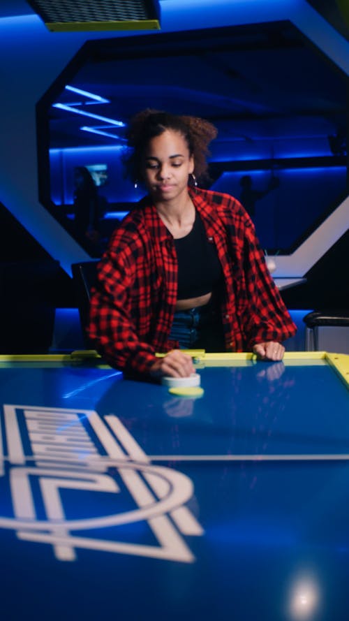 A Young Woman Playing Air Hockey 
