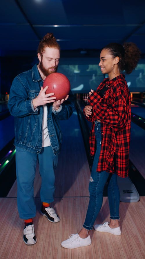 Man and Woman Playing Bowling