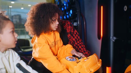 Woman and girls playing arcade game