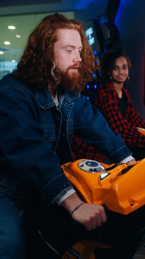 A Man and a Woman Playing in an Arcade