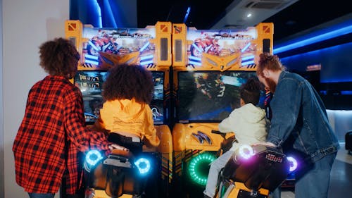 Rear view of family playing arcade game