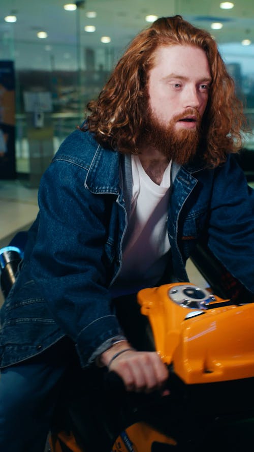 A Bearded Man Riding a Motorcycle Arcade Game