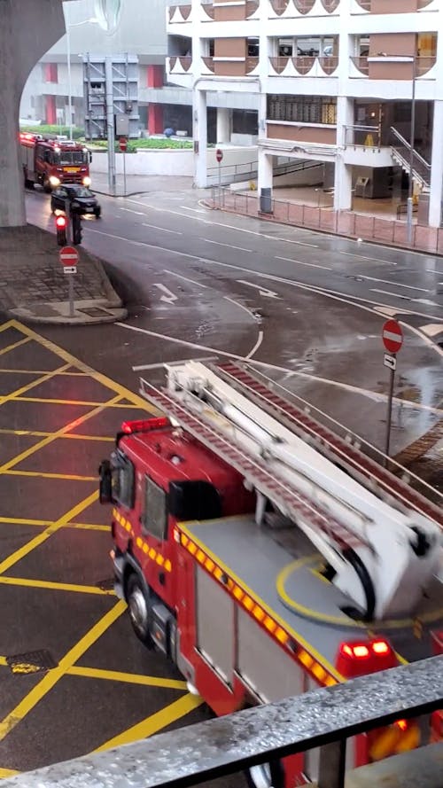 Fire Engine Driving in City During Rain