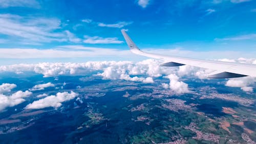 View of Airplane Wing Above Clouds