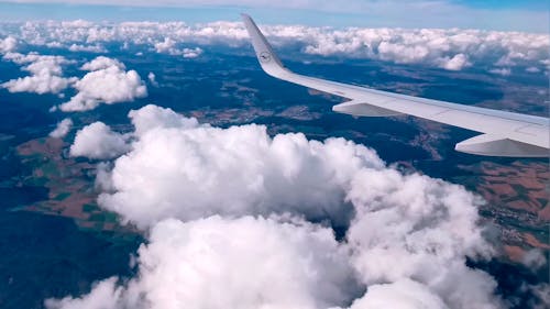 View From Airplane Flying Above Clouds