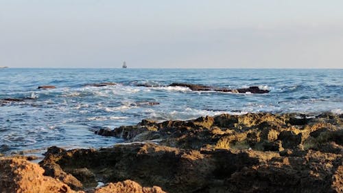 Waves Splashing on Rocky Coastline