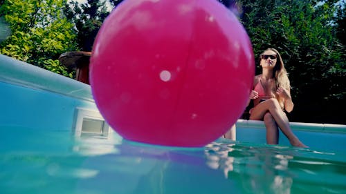 Sexy Women Sitting on a Poolside while Taking a Group Selfie