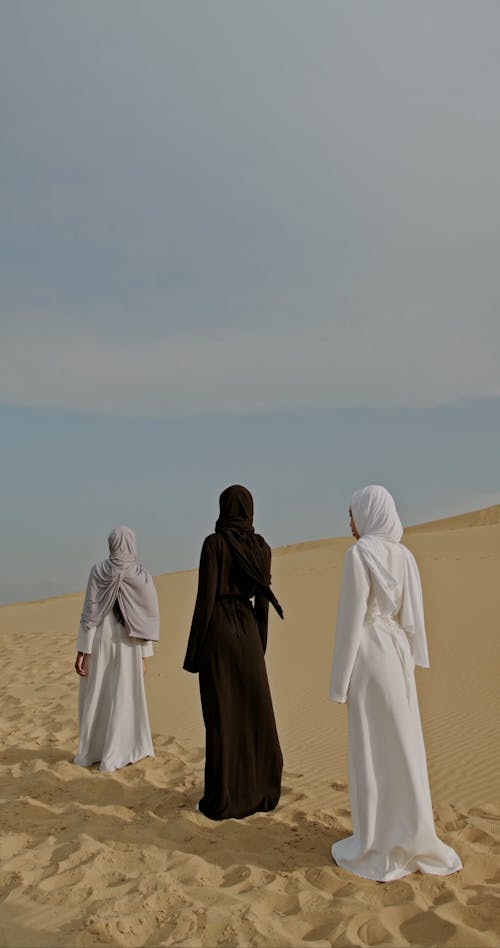 Rear View on Women Standing on Desert