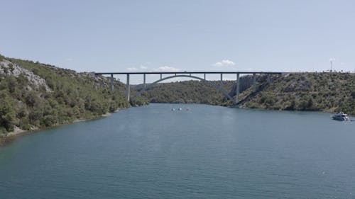  Boats Sailing Under a Bridge