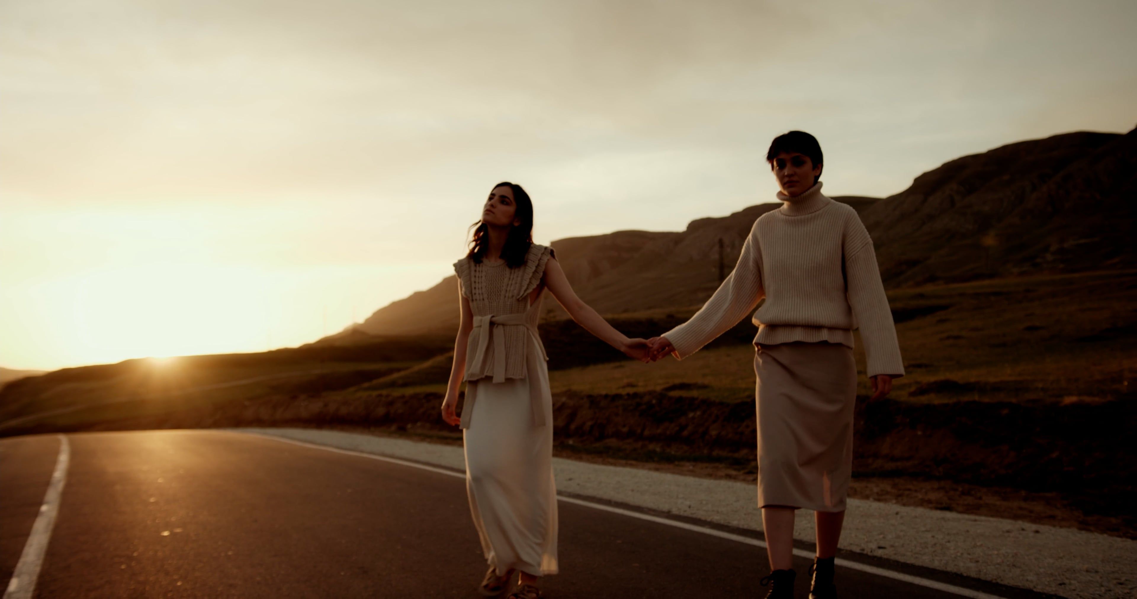 Two Young Women Walking on a Road at Sunset Free Stock Video Footage ...