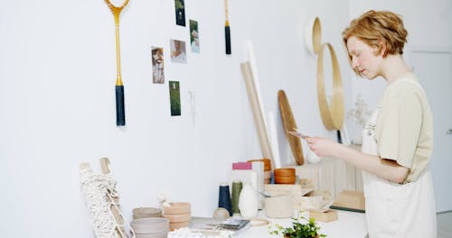 A Woman Putting Pictures on the Wall