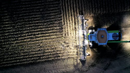 A Drone Footage of a Tractor Plowing at Night