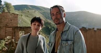 a man and woman looking the view
