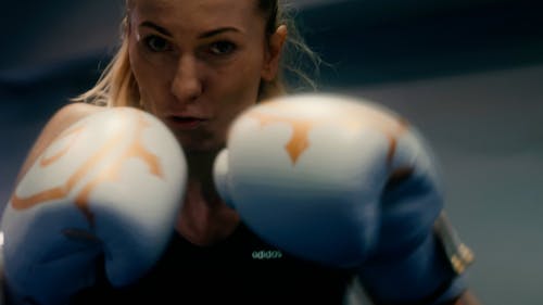 A Woman Shadowboxing While Wearing Boxing Gloves