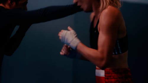 A Man and Woman Doing a Shadowboxing at the Gym