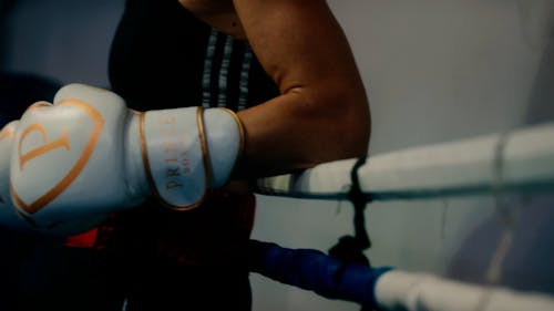 A Person Leaning on the Rope of a Boxing Ring