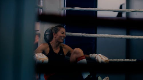 A Woman Sitting in the Boxing Ring 