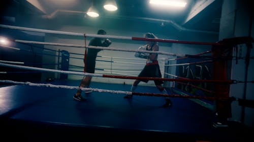 A Man and a Woman Practising Boxing 