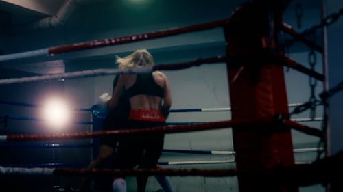 A Man and a Woman Boxing in a Ring 