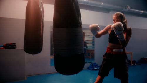 A Woman Training in a Boxing Gym 