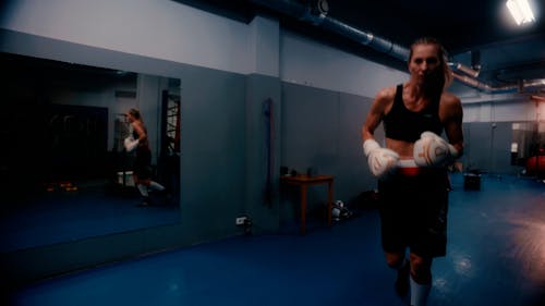 A Woman Hitting the Punching Bag