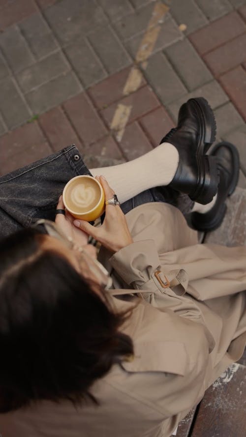 Top View of a Woman Holding a Latte